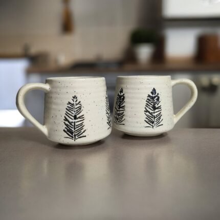 Handmade white ceramic mug with pine tree engraving for tea and coffee