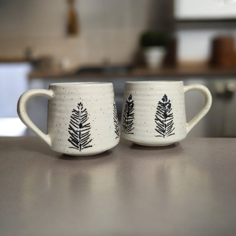 Handmade white ceramic mug with pine tree engraving for tea and coffee