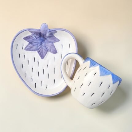 Hand-painted blue ceramic mug with strawberry shaped saucer