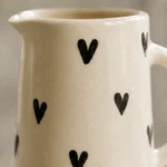 Close-up of handpainted black heart design on ceramic jug