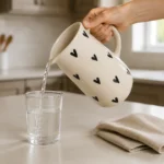 Handpainted ceramic heart jug with black hearts pouring water