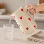 Handpainted ceramic water jug pouring water