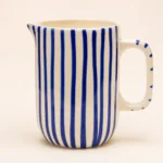 Blue striped ceramic mini jug with handpainted vertical stripes and pouring spout