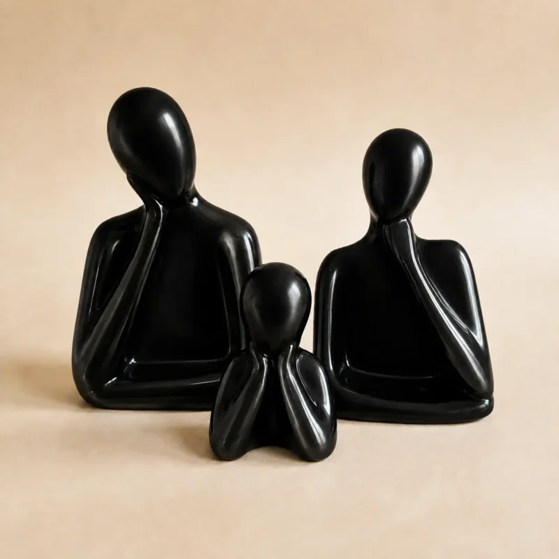 Black glossy ceramic family sculpture set of three featuring father, mother and child