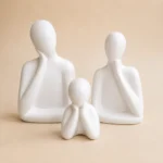 White ceramic family sculpture set of three featuring father, mother and child