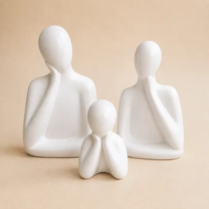 White ceramic family sculpture set of three featuring father, mother and child