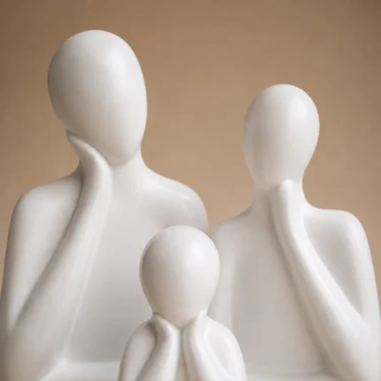 Close-up of white ceramic father mother and child family figures