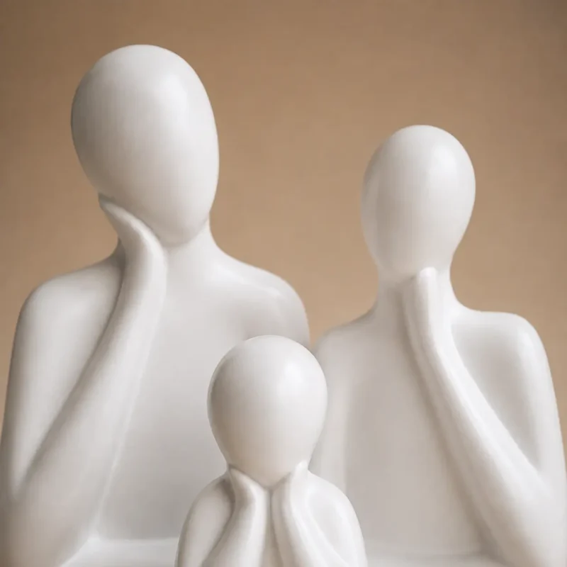 Close-up of white ceramic father mother and child family figures