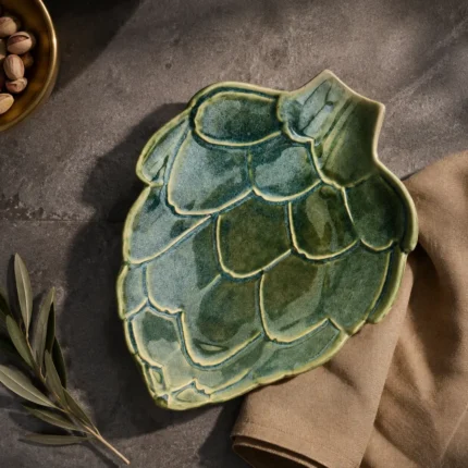 Green ceramic serving platter with artichoke leaf design viewed from above