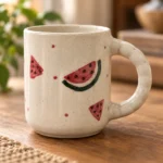 Close-up of hand-painted watermelon design and ceramic glaze detail on ArtyCera mug