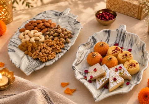 Italian marble finish ceramic serving platters with Diwali mithai and dry fruits on a festive table